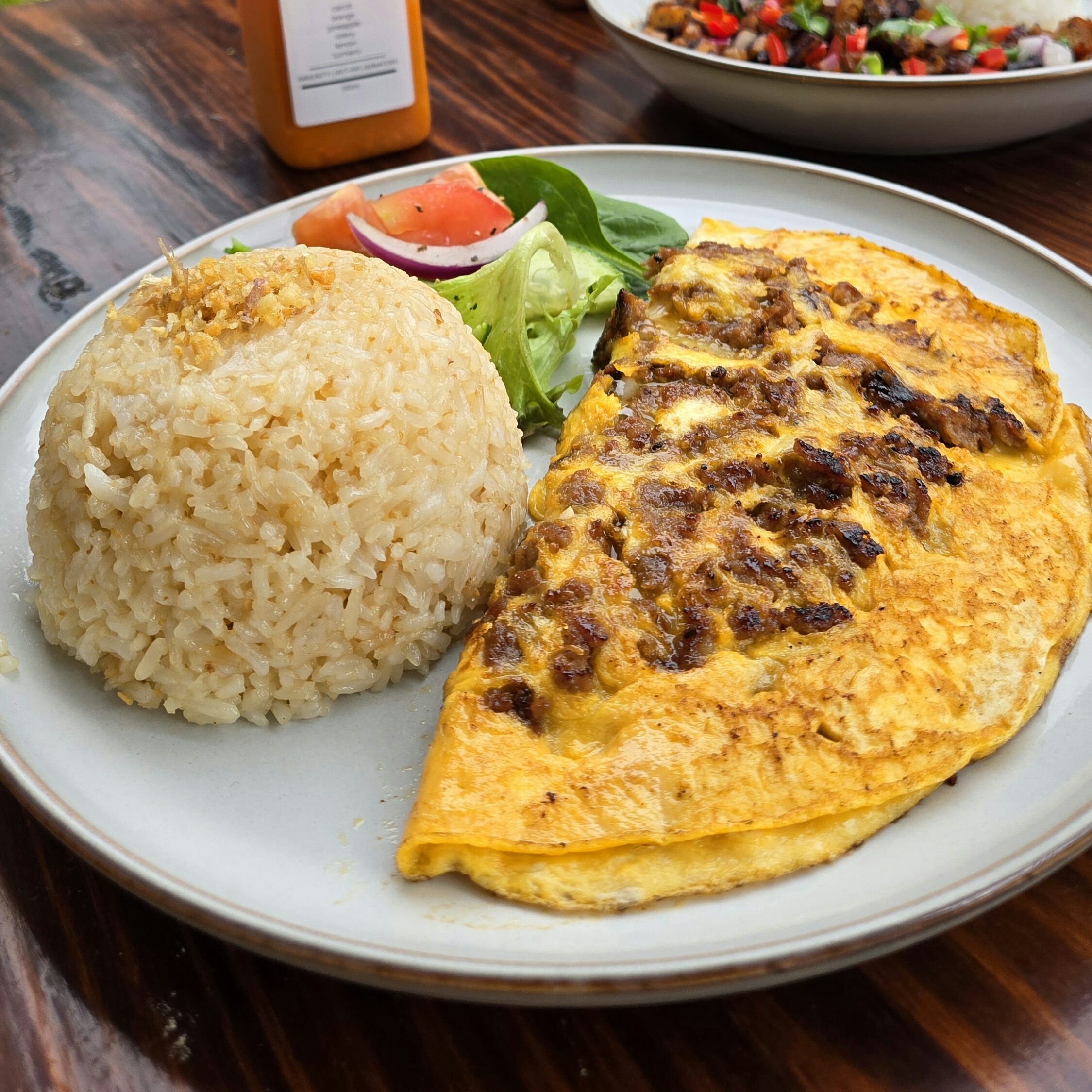 Longganisa omelette with garlic fried rice and salad at Descanso Café, Newtown Sydney.