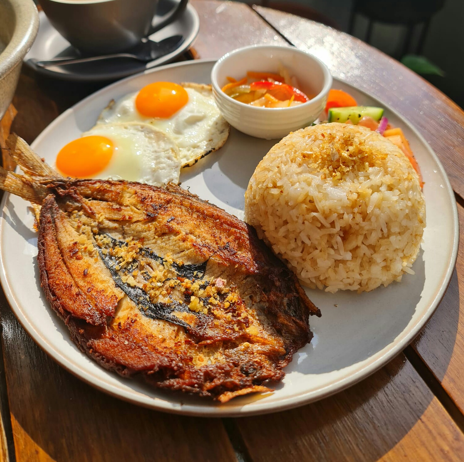 Bangsilog Filipino breakfast with fried bangus, garlic rice, eggs, and atchara at Descanso Café Newtown Sydney.
