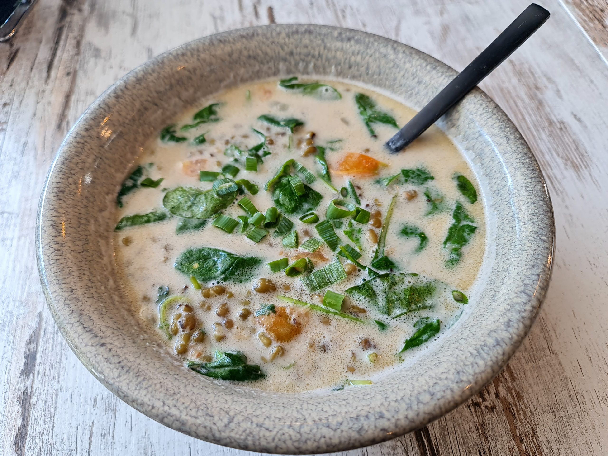Filipino mung bean stew with tomatoes, spinach, and coconut milk served at Descanso Café in Newtown Sydney.