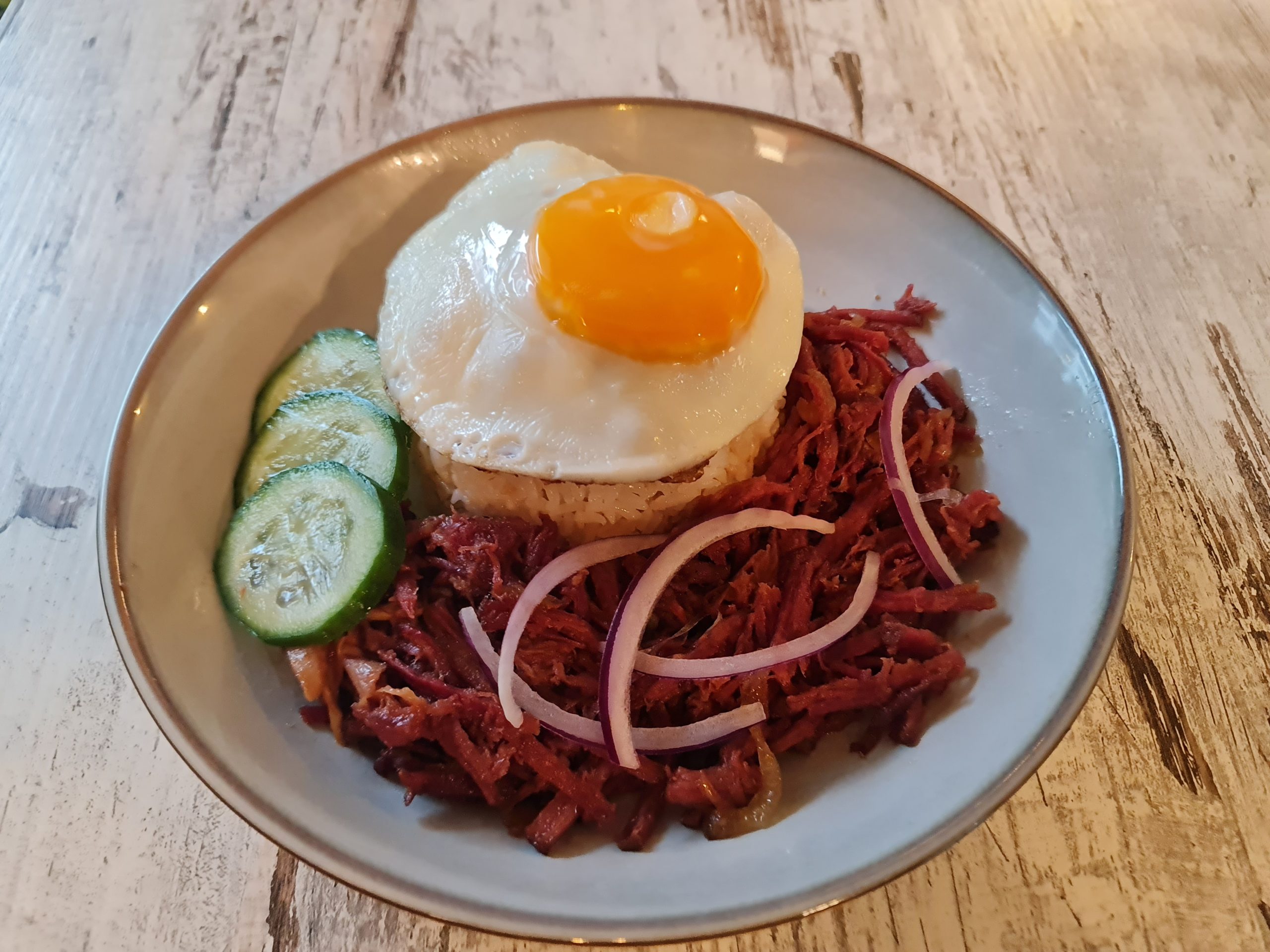 Cornsilog Filipino breakfast with corned beef, garlic rice, and sunny-side-up egg at Descanso Sydney